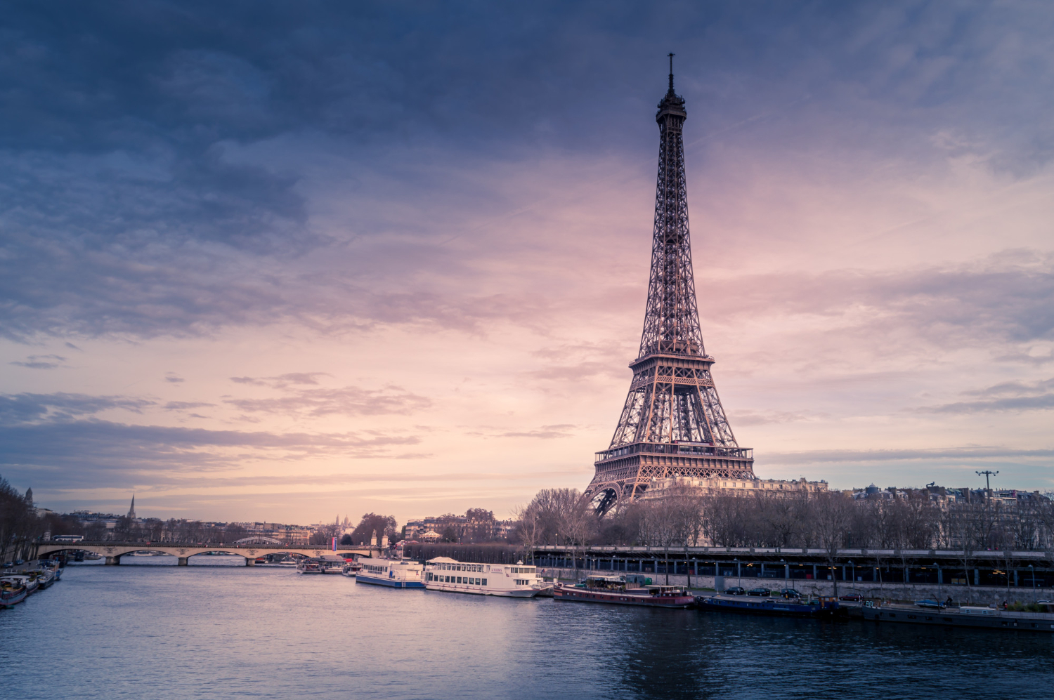 beautiful-wide-shot-eiffel-tower-paris-surrounded-by-water-with-ships-colorful-sky (1)